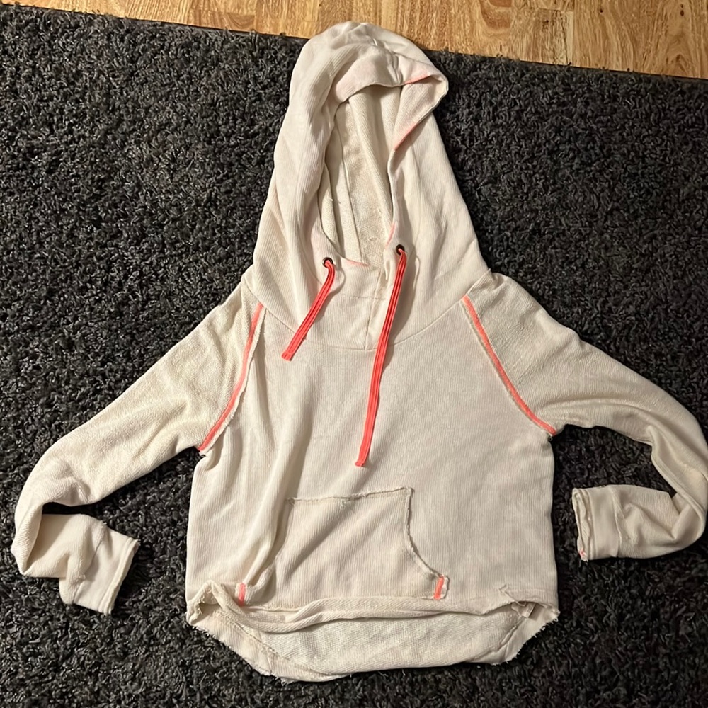 Never worn We the Free sweatshirt. Cream with pink detail on seams.